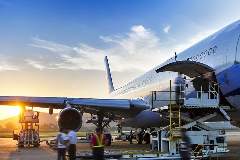 Airplane near the terminal in anairport at the sunset